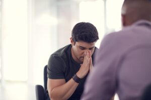 troubled man seeks emotional support in his own language