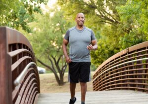 A man jogging through the park - Our Community Workshops aim to promote evidence-based knowledge and support a healthier lifestyle and general wellbeing.